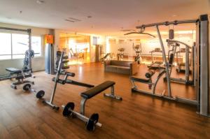 a gym with several exercise equipment in a room at The Square Surabaya Hotel in Surabaya