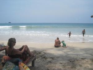 a group of people sitting on the beach at JJ Beach Resort & JJ Seafood in Ko Phayam