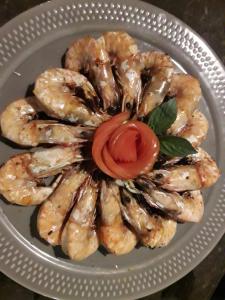 a plate of shrimp with a tomato on it at JJ Beach Resort & JJ Seafood in Ko Phayam