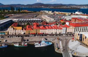 an aerial view of a city with boats in the water at The Henry Jones Art Hotel in Hobart