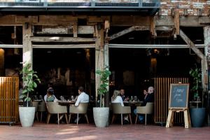 a group of people sitting at tables in a restaurant at The Henry Jones Art Hotel in Hobart