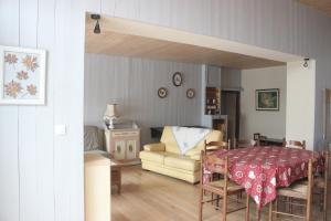 a living room with a table and a couch at gîte de la core in Clézentaine