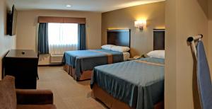 Postel nebo postele na pokoji v ubytování Epic Hotel