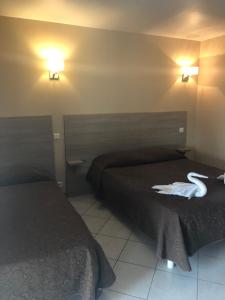 Postel nebo postele na pokoji v ubytování Hotel Clair de Lune