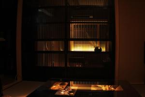 a dark room with a table in front of a window at Kyomachiya Ebisu Private Luxury Townhouse in Higashiyama in Kyoto