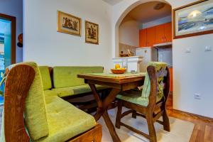 a kitchen with a table and a couch at Allegro Apartment Sekulic in Petrovac na Moru