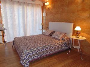 a bedroom with a bed and a table and a window at can jaume portas in Sant Francesc Xavier