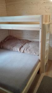 a bunk bed in a wooden room with a mattress at Chata Cep in Třeboň