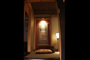 a room with a lamp and a table and a mirror at Kyomachiya Ebisu Private Luxury Townhouse in Higashiyama in Kyoto +28 photos
