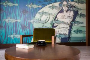 a wooden table with a coffee cup on top of it at Comfort Hotel LT - Rock 'n' Roll Vilnius in Vilnius
