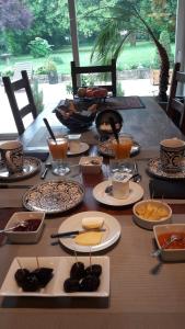 uma mesa longa com pratos de comida em Les Ecureuils em Bougligny