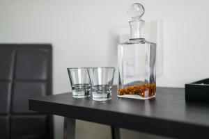 a bottle and two glasses on a table at Comfort Hotel LT - Rock 'n' Roll Vilnius in Vilnius