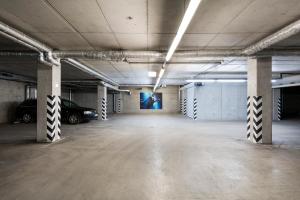 an empty parking garage with a car parked in it at Comfort Hotel LT - Rock 'n' Roll Vilnius in Vilnius