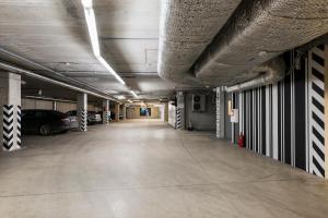 an empty parking garage with a car parked in it at Comfort Hotel LT - Rock 'n' Roll Vilnius in Vilnius