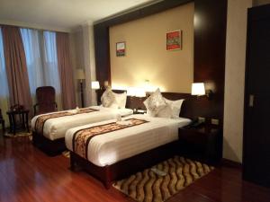 Postel nebo postele na pokoji v ubytování Sherar Addis Hotel
