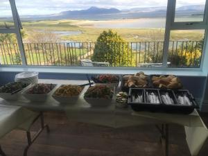a table topped with plates of food and bowls of food at McLoughlins Of Mulranny in Mulranny