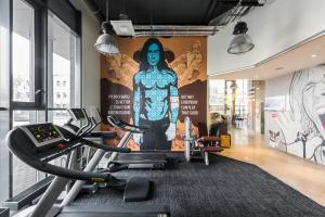 a gym with a mural of a woman on the wall at Comfort Hotel LT - Rock 'n' Roll Vilnius in Vilnius