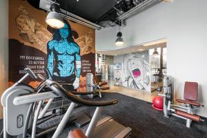 a gym with a large mural on the wall at Comfort Hotel LT - Rock 'n' Roll Vilnius in Vilnius