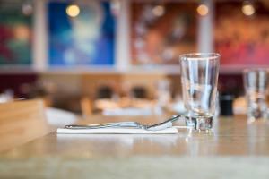 a table with a fork and a glass on it at Comfort Hotel LT - Rock 'n' Roll Vilnius in Vilnius