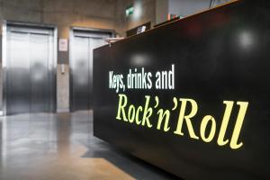 a sign that says rock n roll on a wall at Comfort Hotel LT - Rock 'n' Roll Vilnius in Vilnius