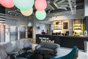 a bar with a couch and chairs and balloons at Comfort Hotel LT - Rock 'n' Roll Vilnius in Vilnius