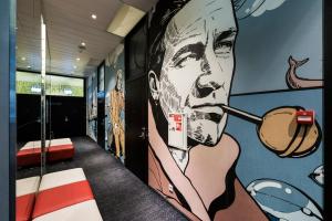 a hallway with a mural of a man smoking a cigarette at Comfort Hotel LT - Rock 'n' Roll Vilnius in Vilnius