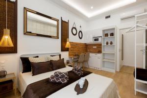 a bedroom with a large bed and a kitchen at Budapest Holidays Residence in Budapest