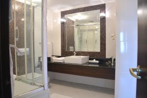 a bathroom with a sink and a mirror at Surmeli Istanbul Hotel in Istanbul