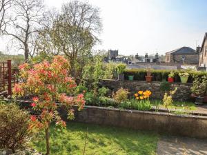 a garden with colourful flowers and plants at Copper Cottage in Ingleton