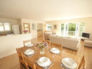 a dining room with a table and chairs and a living room at The Meadow in Feock