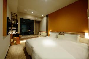 Säng eller sängar i ett rum på Candeo Hotels Tokyo Roppongi