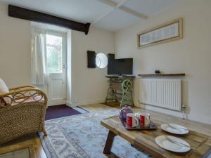 a living room with a coffee table and a tv at The Old Engine House in Bodmin