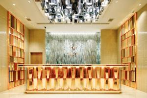 a lobby with chairs and a chandelier at Candeo Hotels Tokyo Roppongi in Tokyo