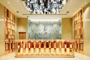 a lobby with chairs and a chandelier at Candeo Hotels Tokyo Roppongi in Tokyo