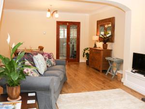 a living room with a couch and a tv at 17 Riverside in Oakamoor