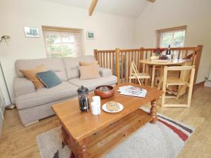 a living room with a couch and a table at Mithian Cottage in St. Agnes 