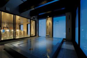 an empty room with a glass door and a large window at Candeo Hotels Tokyo Roppongi in Tokyo