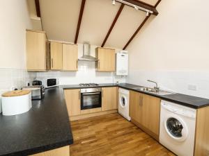 a kitchen with a sink and a dishwasher at Cheshire Cheese Cottage in Chester