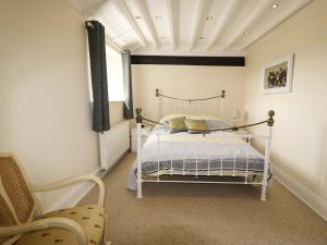 a bedroom with a white bed and a window at Cheshire Cheese Cottage in Chester