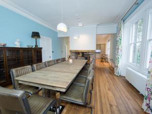 a dining room with a table and chairs and a fireplace at Queen Ann's Close in Chinley