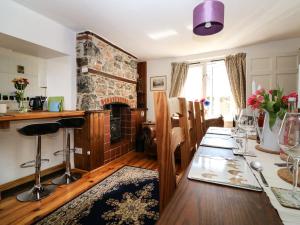 a living room with a table and a fireplace at Medland in Newton Abbot