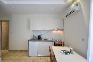 A kitchen or kitchenette at Blue Senses Hotel
