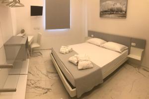 Postel nebo postele na pokoji v ubytování Kalì B&B