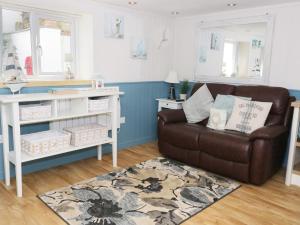 a living room with a couch and a table at The Hideaway in Benllech