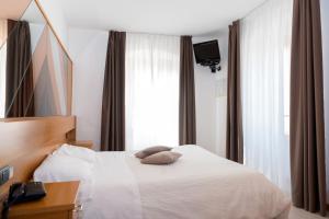 Posteľ alebo postele v izbe v ubytovaní Albergo Ristorante Da Neni