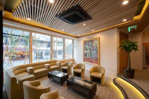 a lobby with a couch and chairs and a table at Terrace Kiyomizu Kyoto in Kyoto