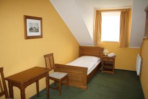 Postel nebo postele na pokoji v ubytování Hotel Bouček