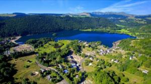 an aerial view of a lake in the countryside at Villa MARIA in Chambon-sur-Lac