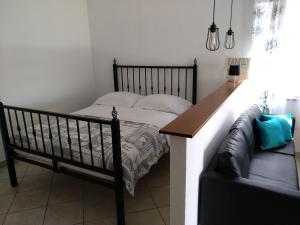 a bedroom with a bed and a couch at Apartments Anica in Rovinj