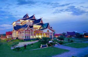 a large house with a gambrel roof at Monoloog Hotel Pekanbaru in Pekanbaru